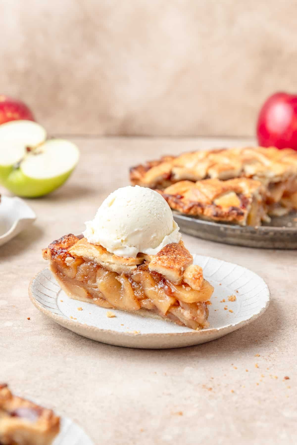 slice of homemade apple pie topped with vanilla ice cream.