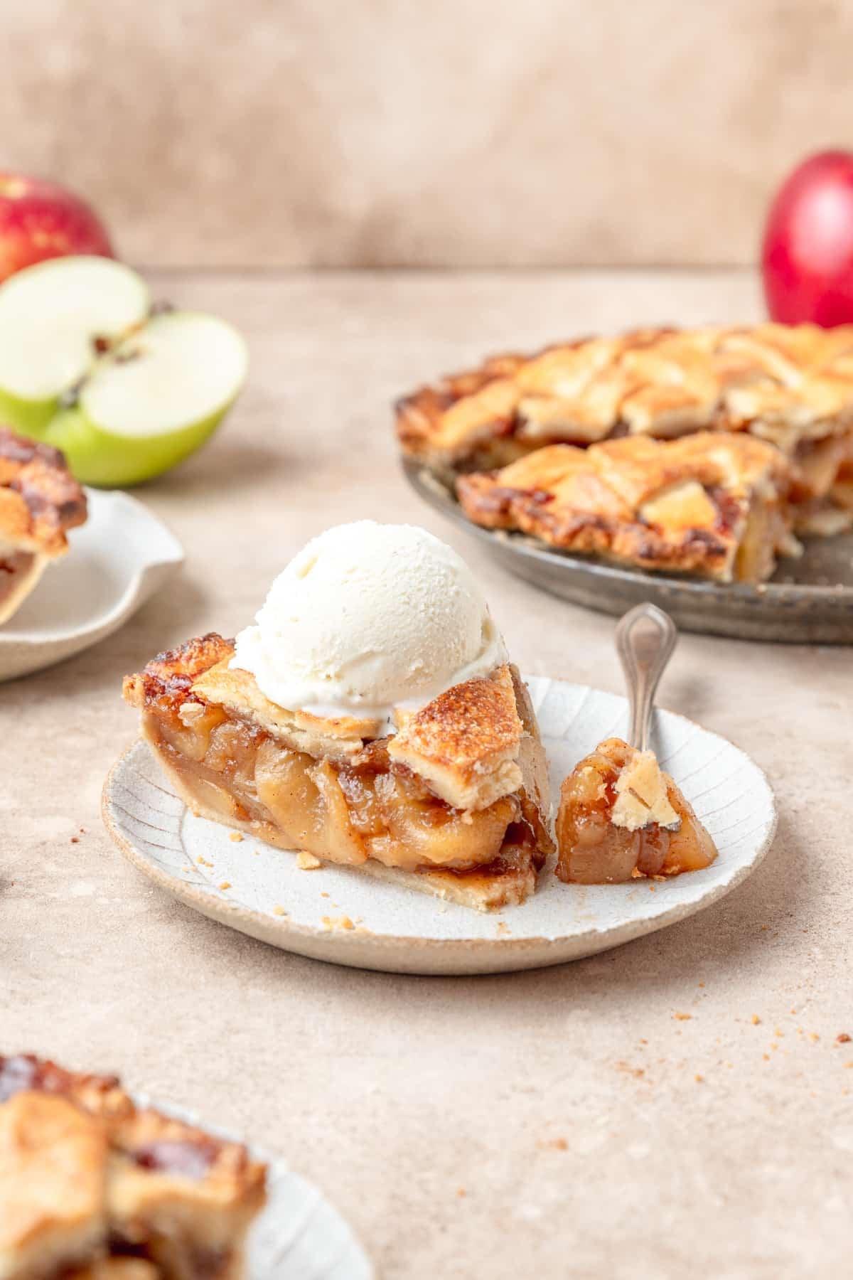 slice of apple pie topped with ice cream.