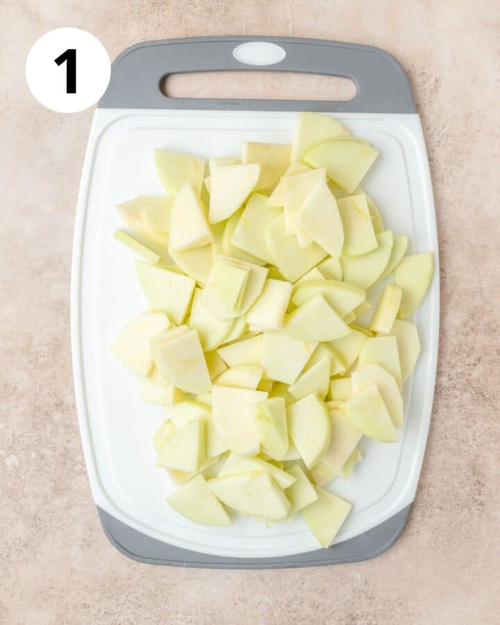peeled and sliced apples on cutting board.