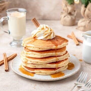 stack of spiced eggnog pancakes topped.