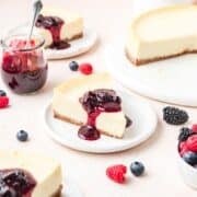 slice of mascarpone cheesecake topped with mixed berry compote.