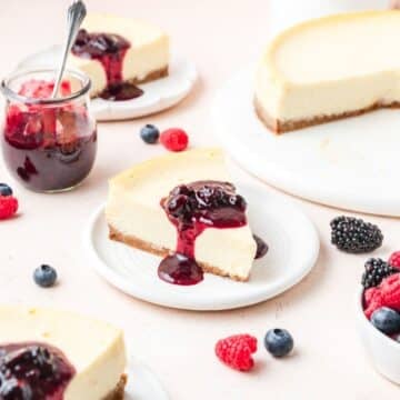 slice of mascarpone cheesecake topped with mixed berry compote.