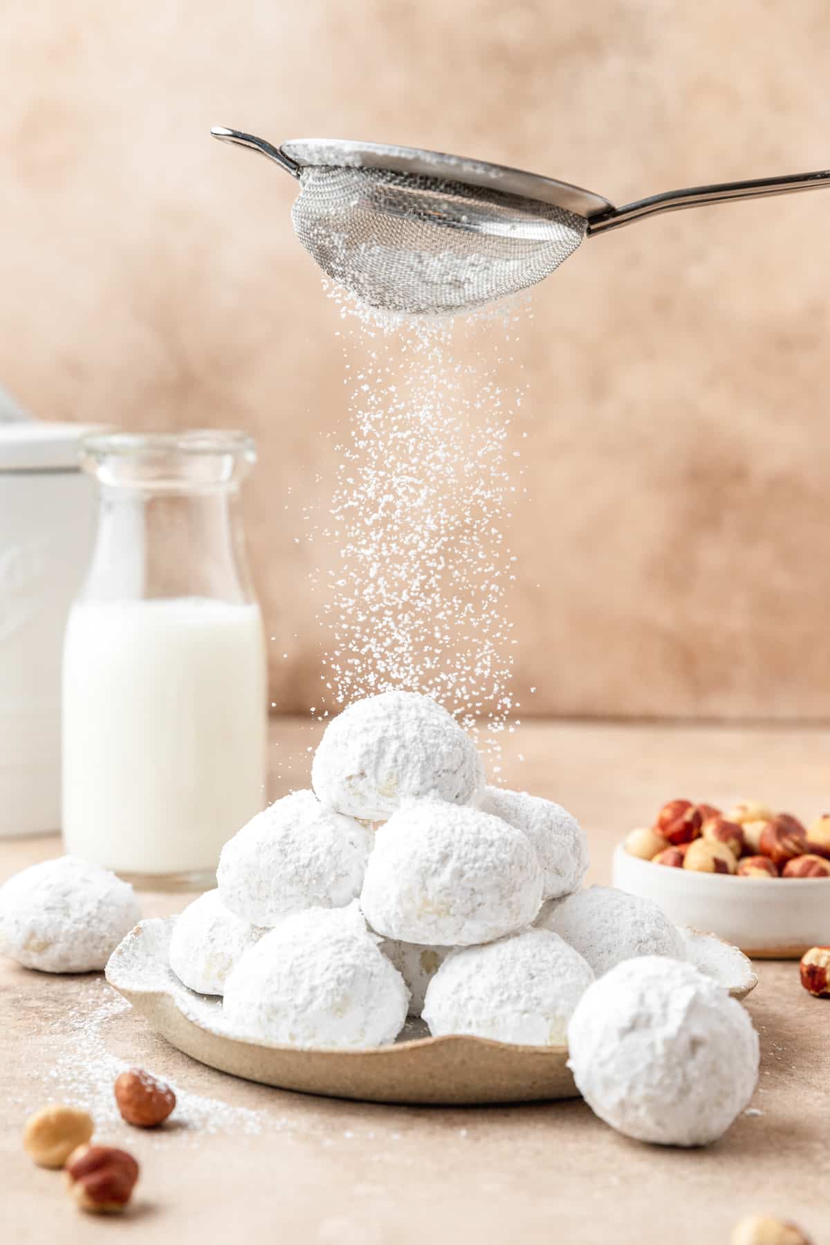 dusting snowball cookies with extra powdered sugar.