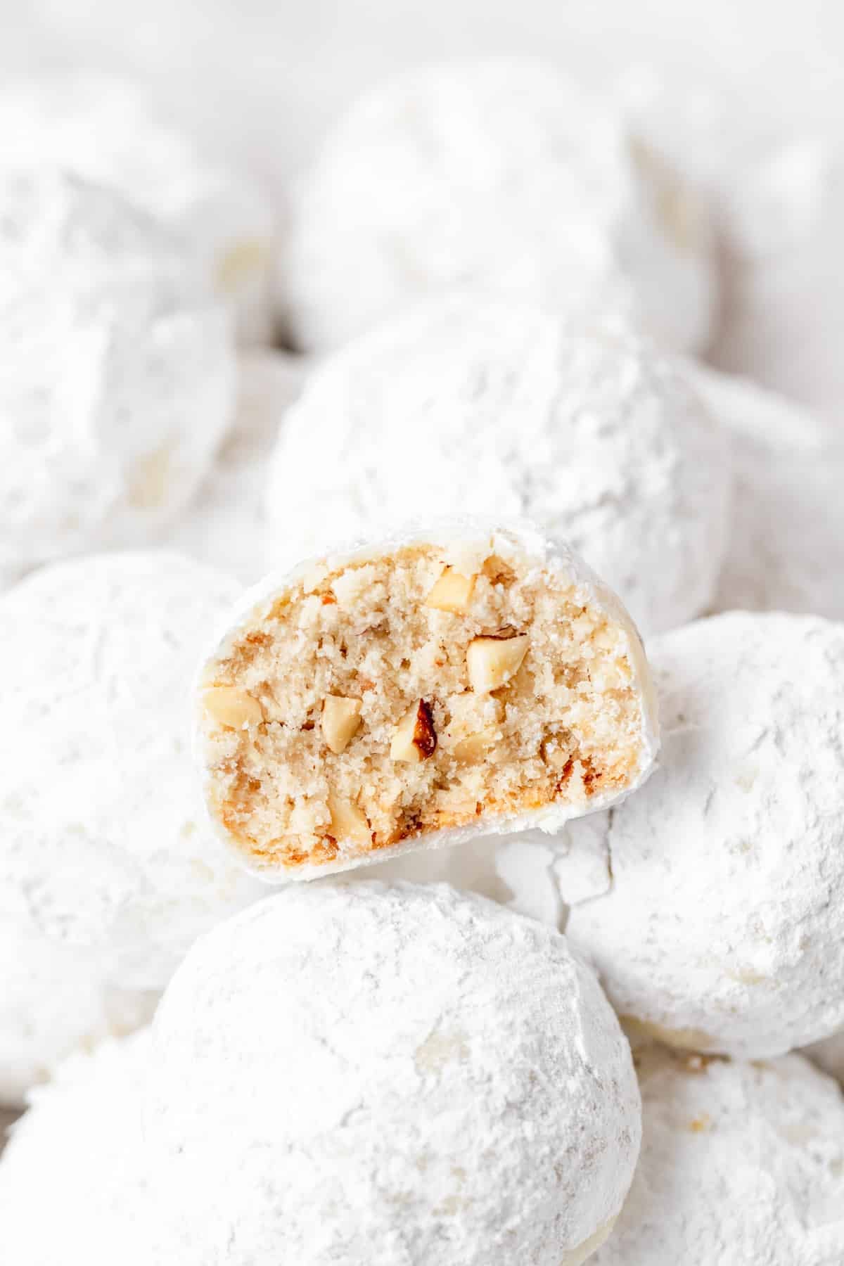 bite taken out of hazelnut snowball cookie.