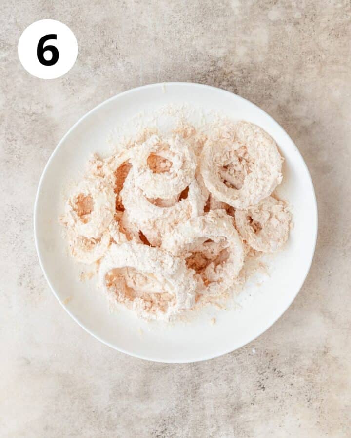 battered and breaded floured onion rings before frying.