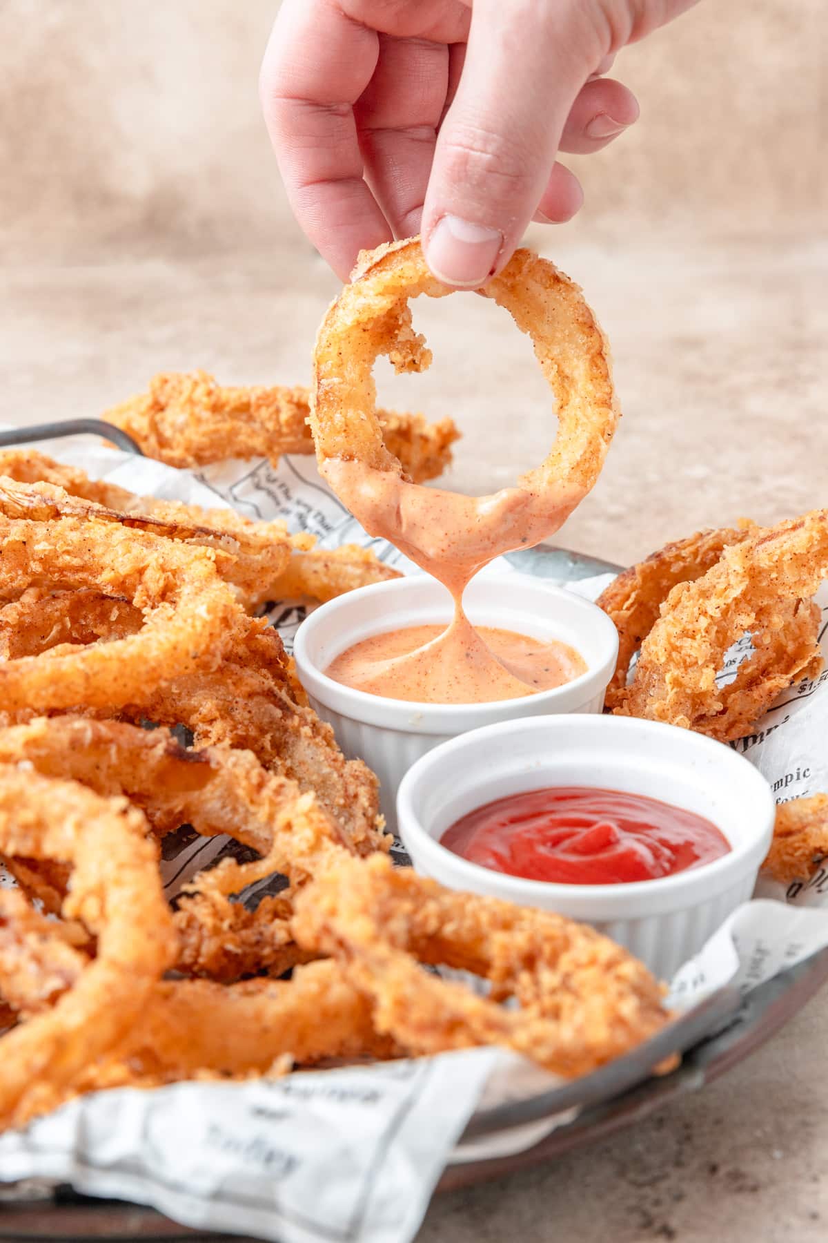 dipping sourdough onion ring in fry sauce.