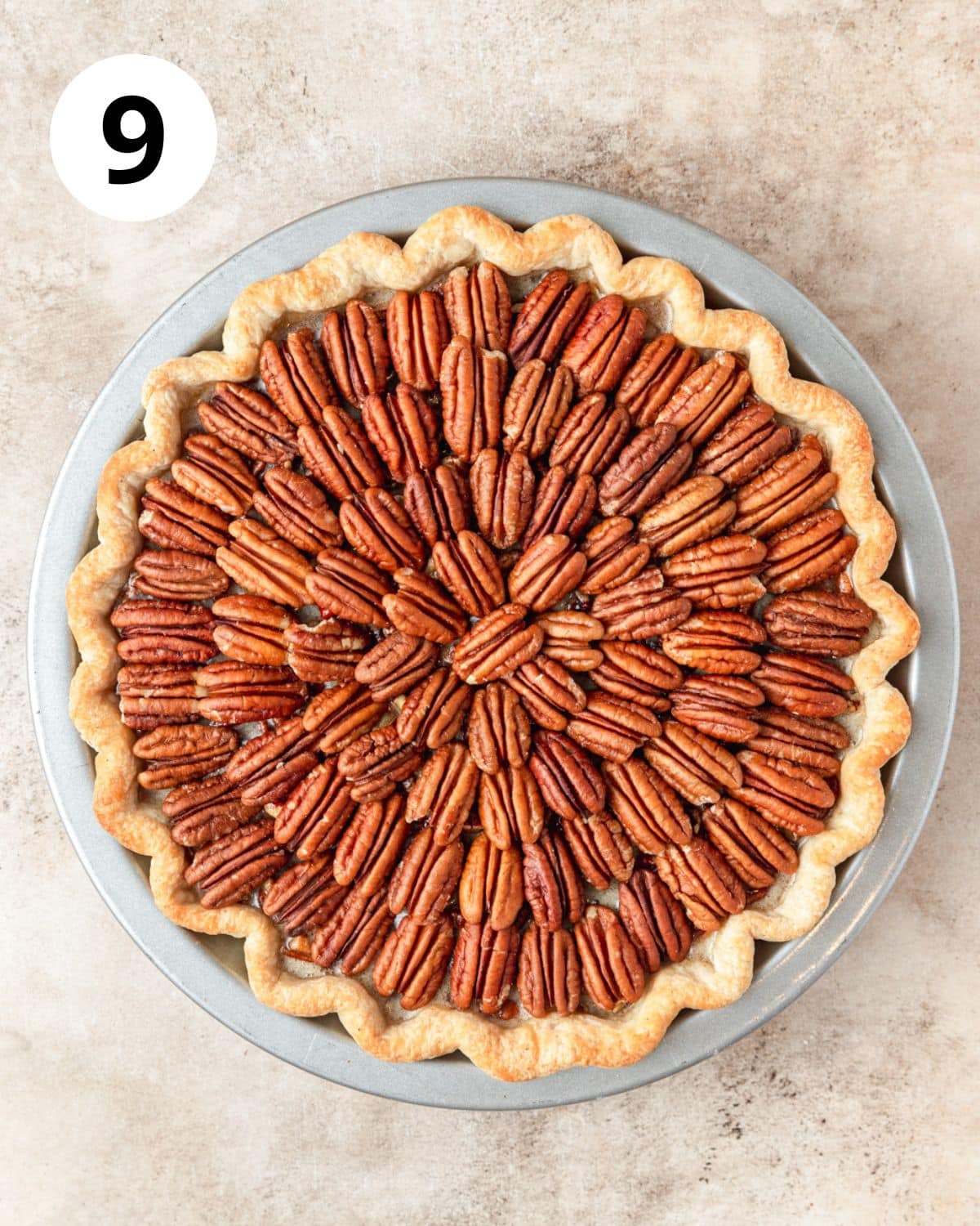 arranging whole pecans on top of pecan pie.