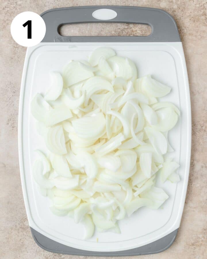 sliced onions on cutting board.