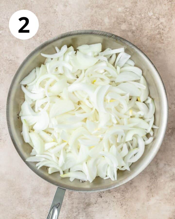 sliced onions in pan.