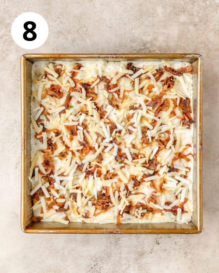 topping dough with caramelized onions and gruyere cheese.