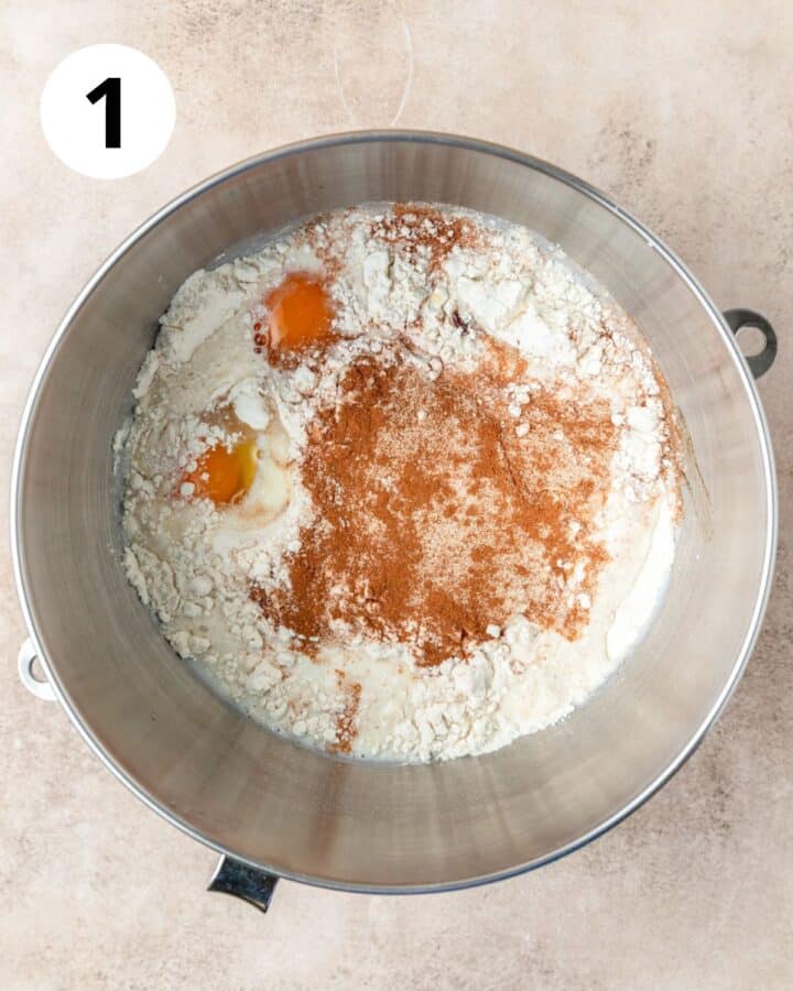 ingredients for cinnamon roll dough in mixing bowl.