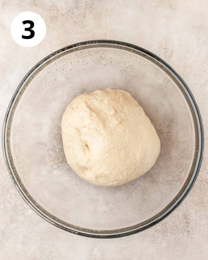 cinnamon roll dough in lightly oiled bowl.