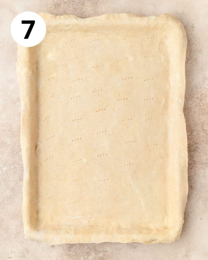pie dough rolled out on sheet pan.