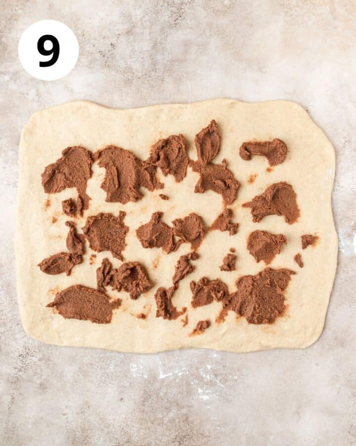dotting cinnamon sugar on dough.
