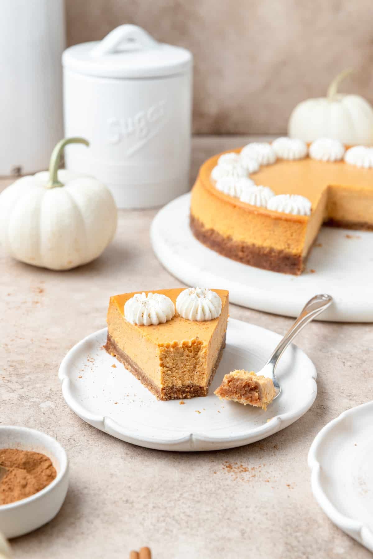 slice of pumpkin cheesecake with bite taken out.